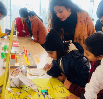 Young innovators showcasing their projects at a school exhibition