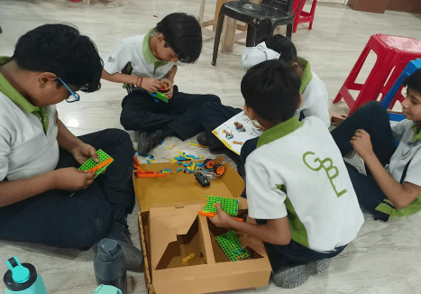 Students building and testing prototypes in a school lab