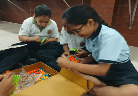 Teacher mentoring students during a STEM activity
